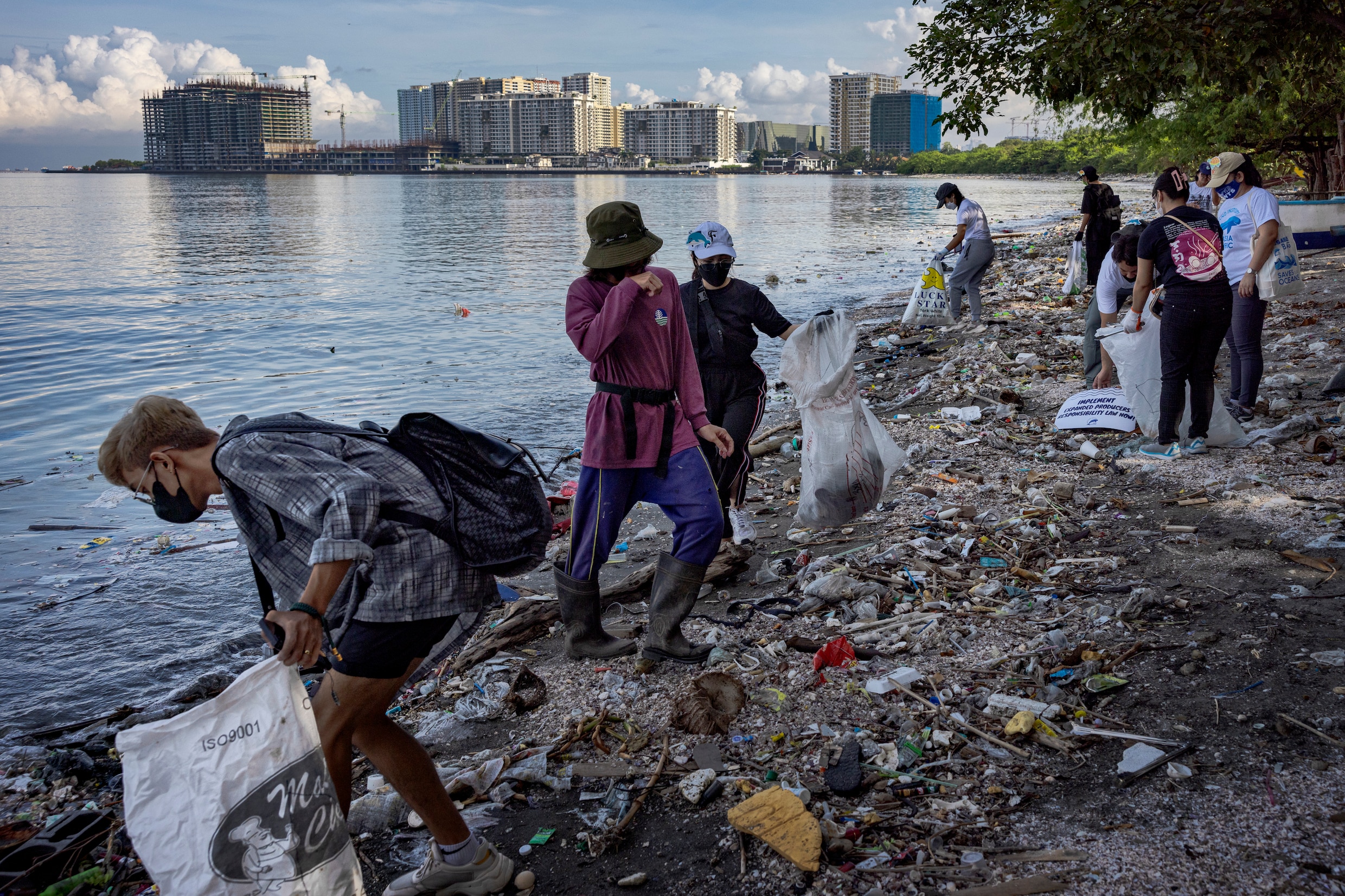 Vrijwilligers verzamelen aangespoeld plastic bij de Filipijnse stad Las Piñas, dat is gelegen aan de baai van Manila.