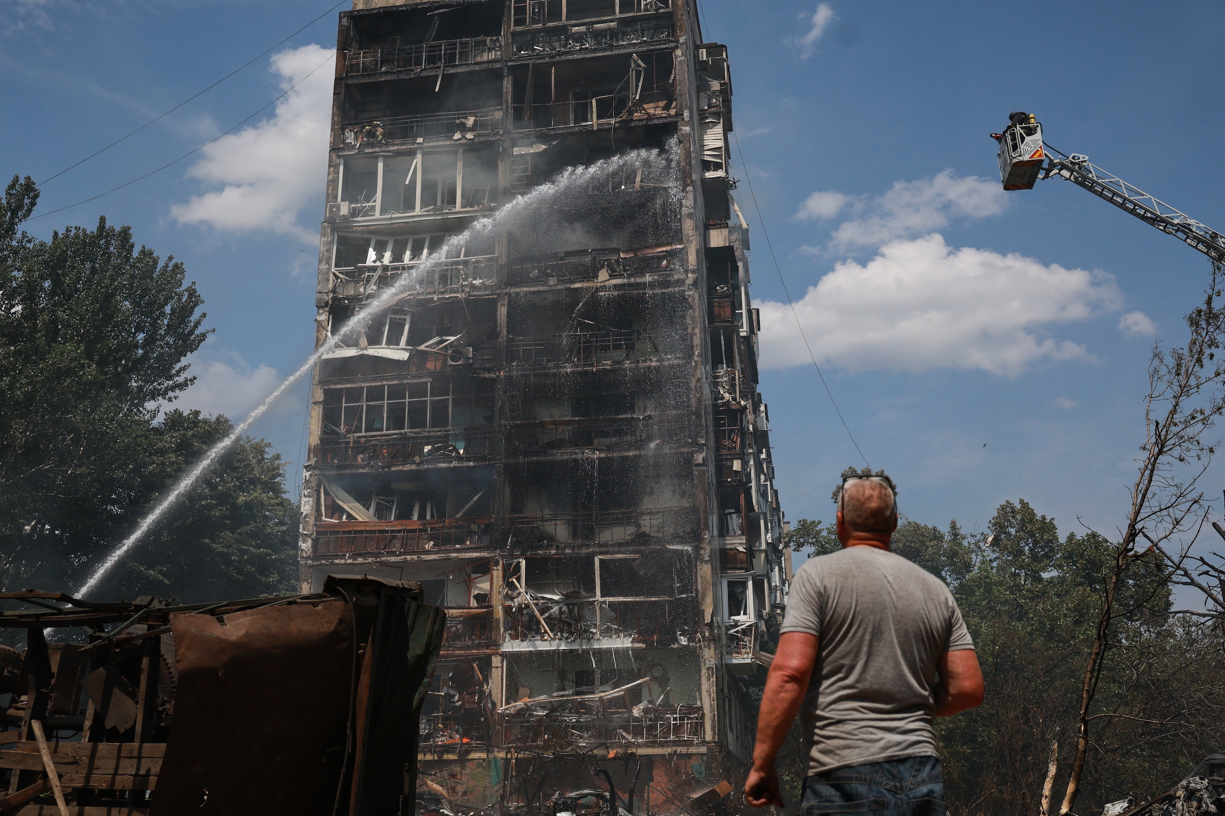 Rescue workers try to put out a fire of a residential building burning after a Russian air attack in Zaporizhzhia, Ukraine, Tuesday, July 21, 2026. (AP Photo/Kateryna Klochko)