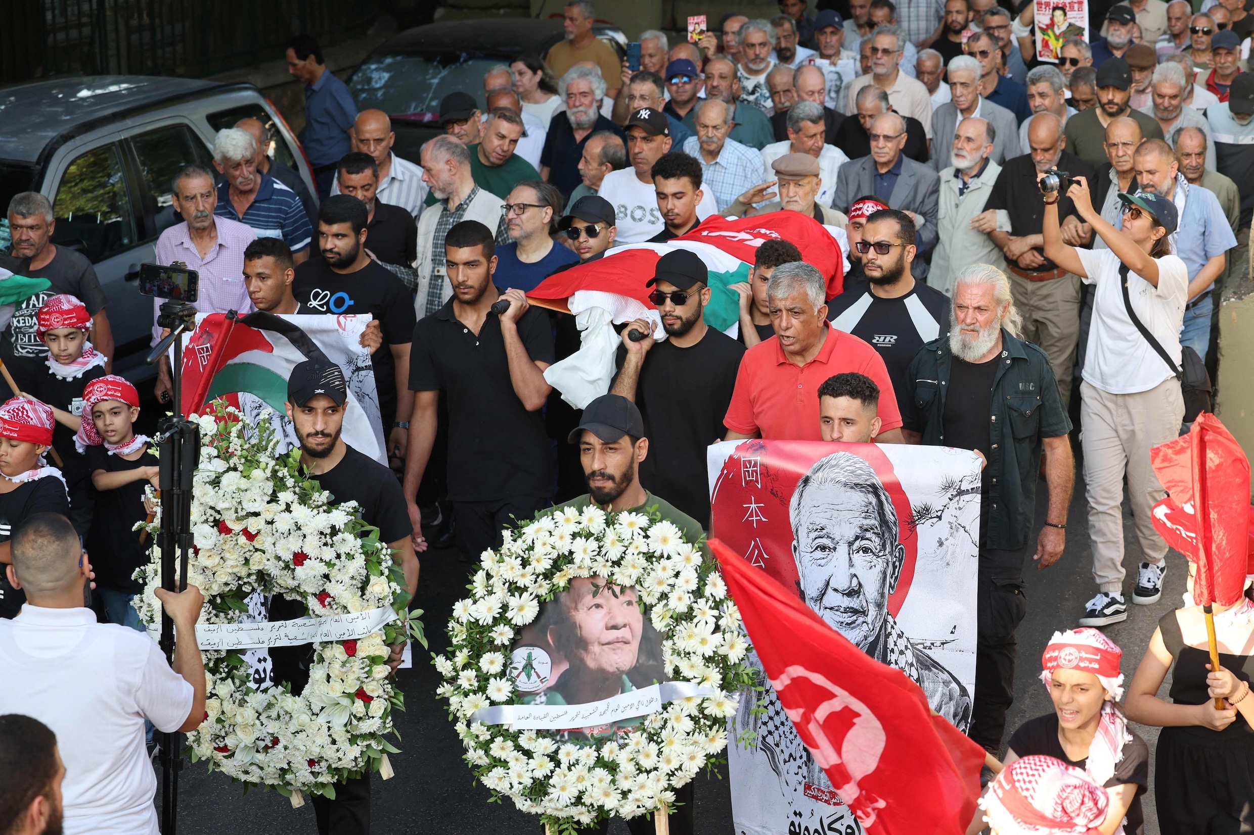 Leden en aanhangers van het Volksfront voor de Bevrijding van Palestina dragen de kist van Kozo Okamoto, die op 23 juli overleed.