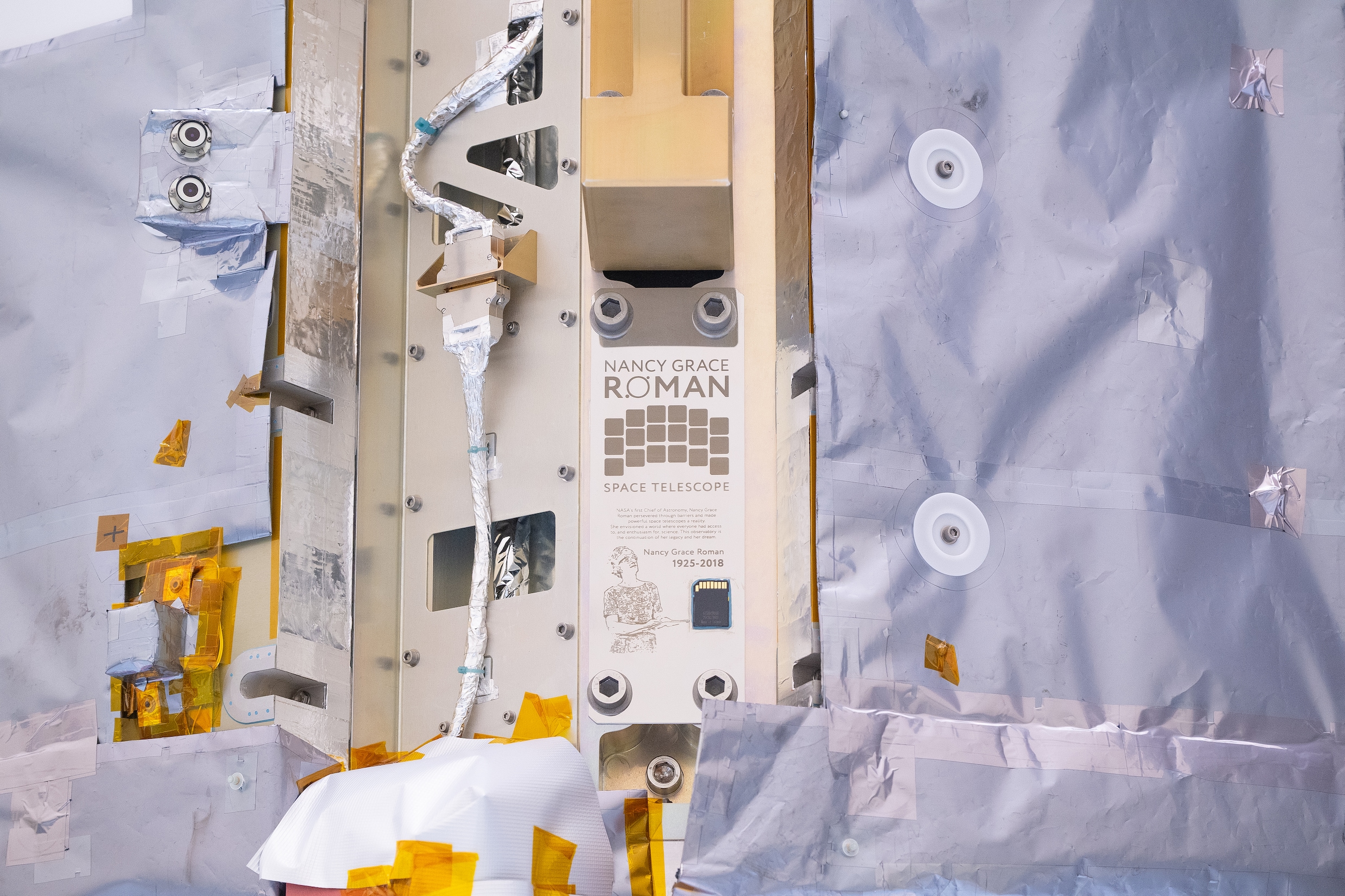 Close ups of a spacecraft in an industrial high bay.