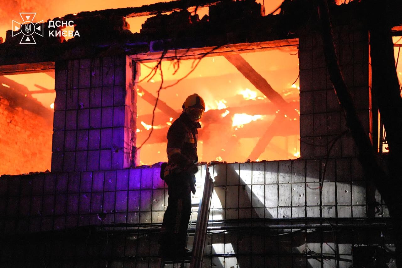 Een reddingswerker bij een pand in Kyiv waar brand is uitgebroken door een Russische aanval.